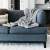 Silky soft Saranoni blanket draped over a cozy couch.