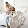 MARBLE FAUX FUR/MINKY XL THROW BLANKETS - Family snuggling up in a soft throw that is perfect for warmth.