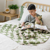 Boy reading in bed with olive checkered MINKY STRETCH RECEIVING BLANKETS - Saranoni