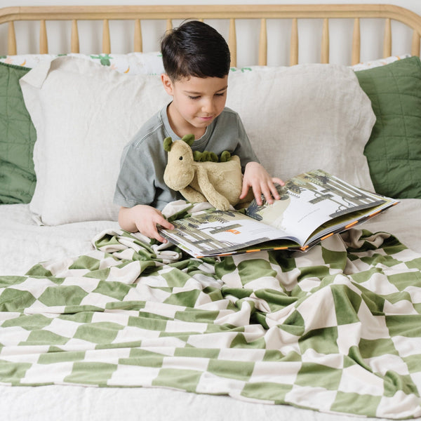 Boy reading book, snuggling with MINKY STRETCH RECEIVING BLANKETS - Saranoni