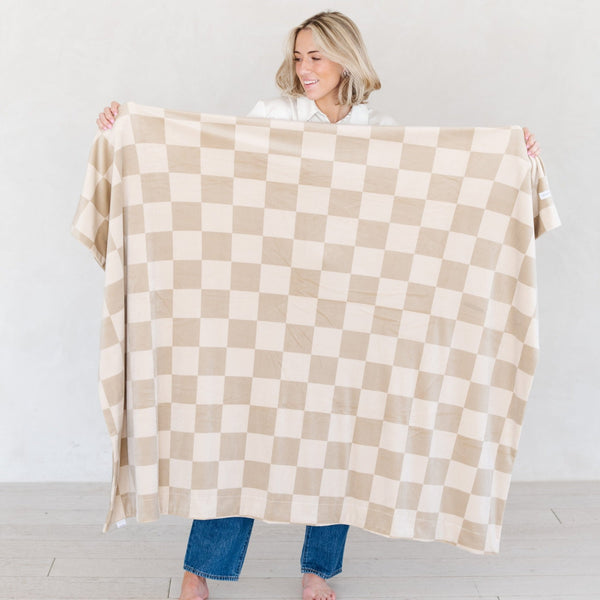 Woman holding out beautiful large checkered MINKY STRETCH XL THROW BLANKETS - Saranoni