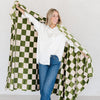 Girl wrapping up in checkered Olive Green MINKY STRETCH XL THROW BLANKETS - Saranoni