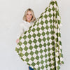 Girl holding out beautiful checkered MINKY STRETCH XL THROW BLANKETS - Saranoni