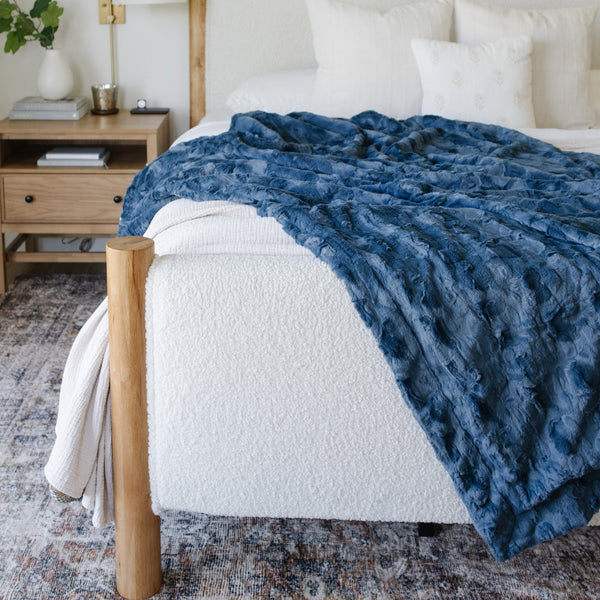 PATTERNED FAUX FUR THROW BLANKETS - Big fluffy Saranoni blanket draped over a modern bed