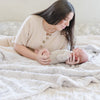 PATTERNED FAUX FUR THROW BLANKETS - Woman and her baby laying around with a plush Saranoni throw