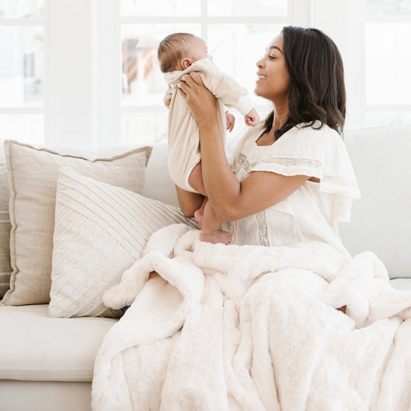 PATTERNED FAUX FUR THROW BLANKETS - Mom and baby enjoying the warmth of the Saranoni throw blanket. 