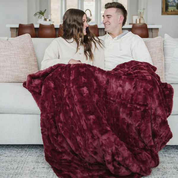 PATTERNED FAUX FUR XL THROW BLANKETS - Couple wrapped in a fluffy Saranoni blanket, feeling cozy and secure.