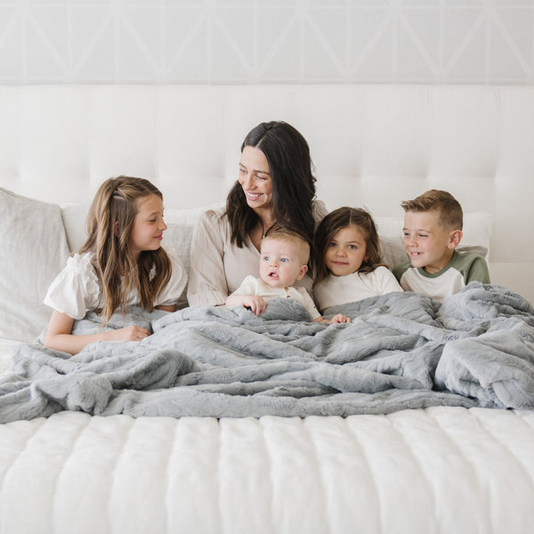 PATTERNED FAUX FUR XL THROW BLANKETS - Saranoni Extra Large Throw Blanket draped over a bed, emphasizing its super soft feel.