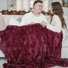 PATTERNED FAUX FUR XL THROW BLANKETS - Couple enjoying a movie night with a Saranoni throw blanket.