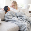 PATTERNED FAUX FUR XL THROW BLANKETS - Luxurious Saranoni blanket on a queen bed, made from high-quality materials.