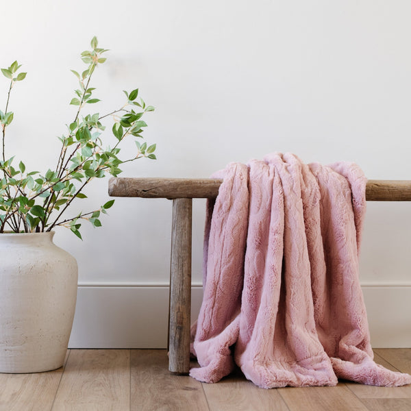 PATTERNED FAUX FUR XL THROW BLANKETS - Fluffy and soft Saranoni blanket draped over a sofa, perfect for comfort.