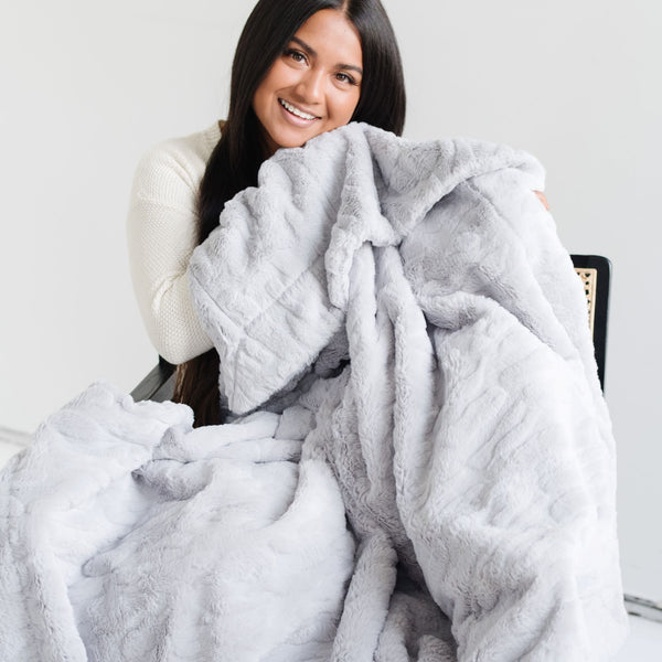 PATTERNED FAUX FUR XL THROW BLANKETS - Extra large Saranoni blanket on a chair, emphasizing its high-quality materials