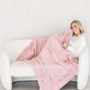 PATTERNED FAUX FUR XL THROW BLANKETS -Big Saranoni blanket folded on a chair, highlighting its elegant design and feel.