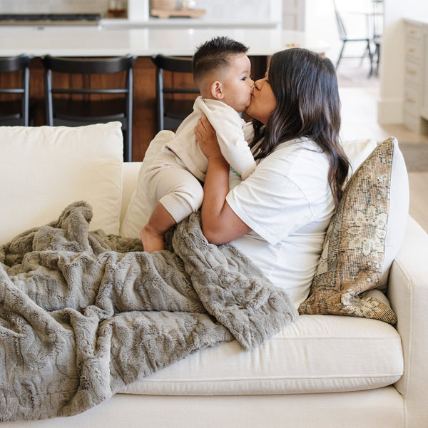 PATTERNED FAUX FUR XL THROW BLANKETS - Elegant Saranoni throw blanket on a chair, showcasing luxurious design.