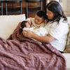 PATTERNED FAUX FUR XL THROW BLANKETS - Fluffy and cozy Saranoni blanket on a chair, providing ultimate comfort.