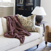 PATTERNED FAUX FUR XL THROW BLANKETS - Soft and elegant Saranoni throw blanket on a couch, perfect for a touch of luxury.