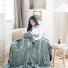 PATTERNED FAUX FUR XL THROW BLANKETS - Durable and comfy Saranoni throw blanket on a chair, perfect for relaxation.