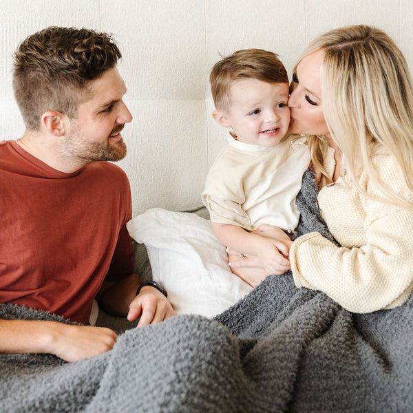 Mom giving baby boy a kiss, wrapped together in soft and cozy Charcoal RIBBED BAMBONI KING BLANKETS - Saranoni