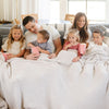 Family having a movie night with beautiful, soft and stretchy Light Gray Moonbeam RIBBED BAMBONI KING BLANKETS - Saranoni