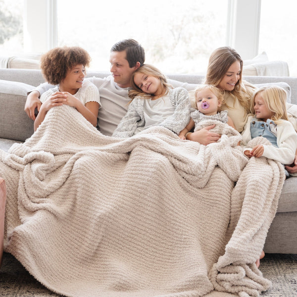 Family of six snuggled together on couch with extra soft Light Gray Moonbeam RIBBED BAMBONI KING BLANKETS - Saranoni