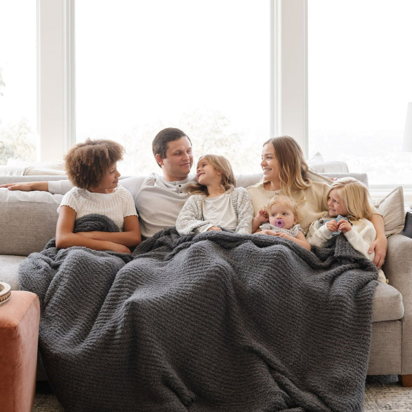 Family of six snuggled on couch with Charcoal RIBBED BAMBONI KING BLANKETS - Saranoni