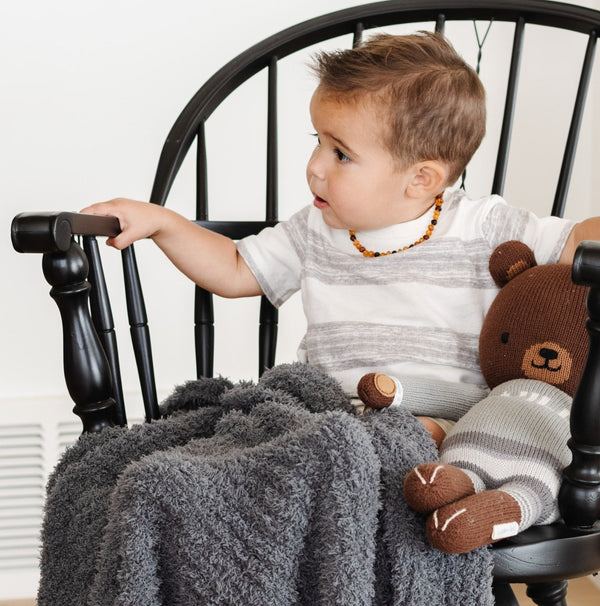 Little boy on rocking chair with stuffed animal, with beautiful Charcoal RIBBED BAMBONI MINI BLANKETS - Saranoni