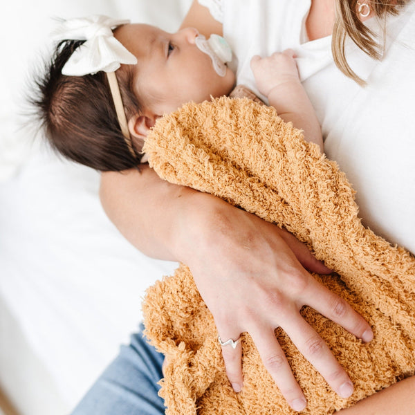 Newborn baby girl wrapped in beautiful, soft Golden RIBBED BAMBONI MINI BLANKETS - Saranoni