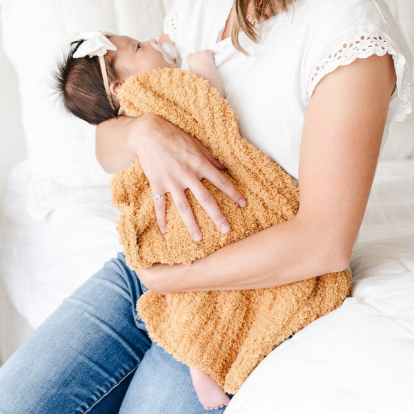 Mom holding baby wrapped in a super cozy and soft Golden RIBBED BAMBONI MINI BLANKETS - Saranoni