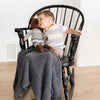 Little boy rocking in a chair with beautiful Charcoal RIBBED BAMBONI RECEIVING BLANKETS - Saranoni