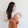 Mom and newborn baby wrapped in super soft and cozy burnt orange GingerRIBBED BAMBONI RECEIVING BLANKETS - Saranoni