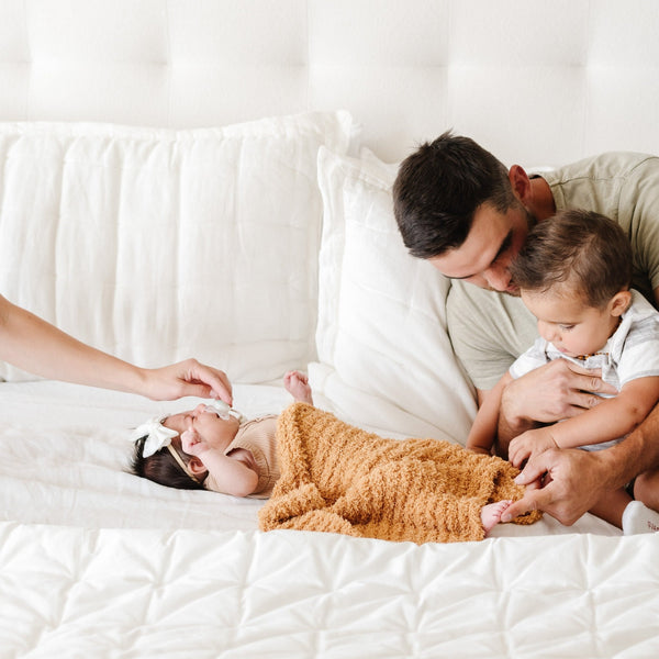 Dad playing with little boy and newborn girl wrapped in beautiful Yellow Golden RIBBED BAMBONI RECEIVING BLANKETS - Saranoni