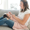 Mom playing with baby girl, laying with super stretchy soft light pink Cameo RIBBED BAMBONI RECEIVING BLANKETS - Saranoni