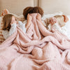 Three little girls hiding under beautiful Light Pink Cameo RIBBED BAMBONI THROW BLANKETS - Saranoni