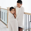 Young brothers wrapped together in light and breathable Light Gray Moonbeam RIBBED BAMBONI THROW BLANKETS - Saranoni