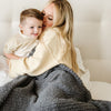 Mom and son snuggling with extra cozy and soft Charcoal RIBBED BAMBONI THROW BLANKETS - Saranoni