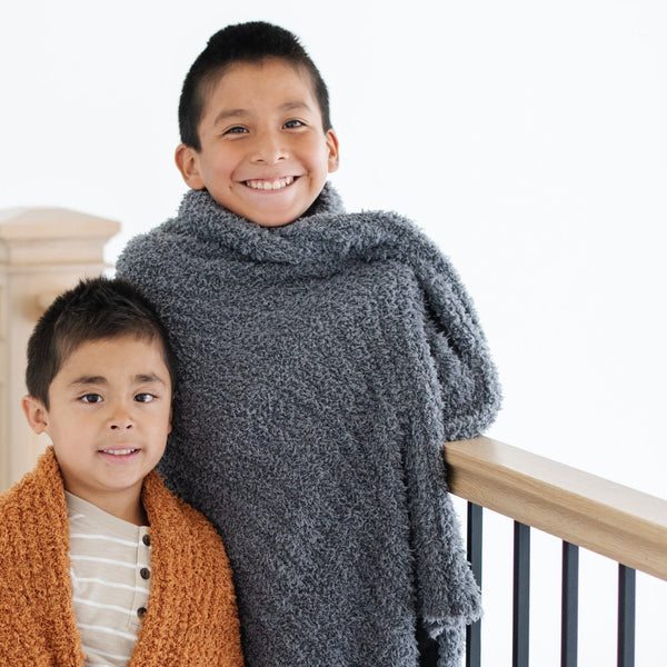 Little brothers wrapped in their favorite super soft and stretchy, cozy and warm RIBBED BAMBONI TODDLER BLANKETS - Saranoni