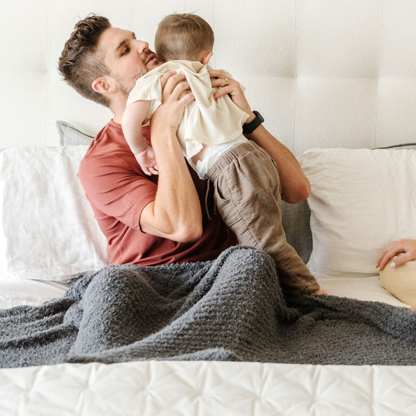 Dad and son playing together with a beautiful, extra soft and comfy Charcoal RIBBED BAMBONI TODDLER BLANKETS - Saranoni