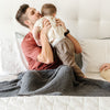 Dad and son playing together with a beautiful, extra soft and comfy Charcoal RIBBED BAMBONI TODDLER BLANKETS - Saranoni