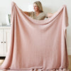 Woman holding up beautiful, extra stretchy soft light pink Cameo RIBBED BAMBONI XL BLANKETS - Saranoni