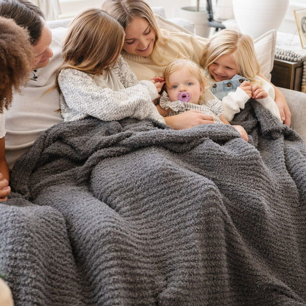 Family all laying together under their favorite, super soft Charcoal RIBBED BAMBONI XL BLANKETS - Saranoni