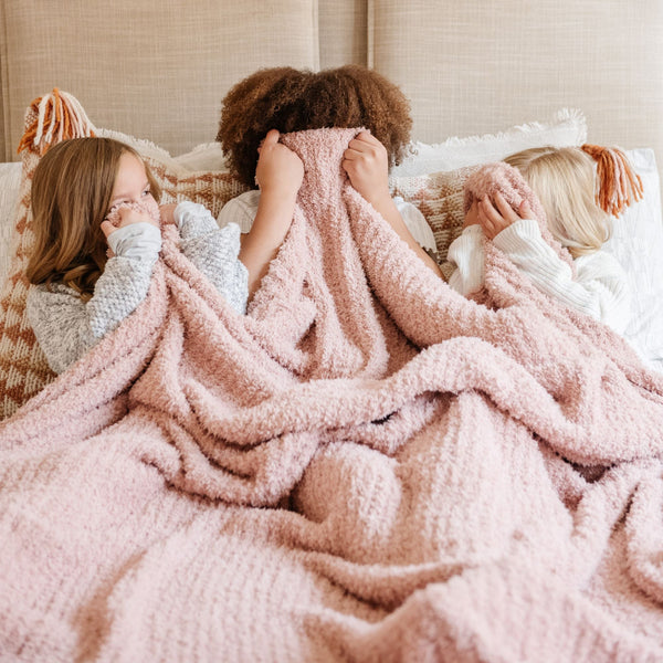 Three little girls playing with a beautiful, extra soft and luxurious light pink Cameo RIBBED BAMBONI XL BLANKETS - Saranoni