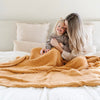 Mom and daughter snuggling together under a beautiful, warm and cozy Golden Yellow RIBBED BAMBONI® XL BLANKETS - Saranoni