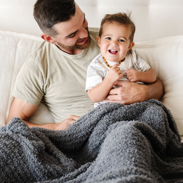 Dad and son snuggled up together in extra soft and breathable Charcoal RIBBED BAMBONI XL BLANKETS - Saranoni