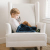 A little boy watches a show while cuddling with a Mini Navy Colored Lush Saranoni Blanket. The soft blanket is a small blanket and a baby blanket or toddler blanket.