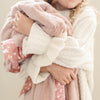 Gentle receiving blanket with a soft, plush feel, designed to keep your little one snug.