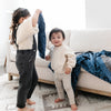 Sibling playtime with cozy mini blanket featuring a smooth satin back, perfect for snuggling up with a touch of elegance.