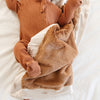 Comfortable mini blanket with a satin back, designed to offer warmth with a luxurious, silky underside.