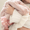 Plush mini blanket with a silky satin back, combining the warmth of soft fabric with the luxurious feel of satin.