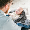 Father and child snuggling with a mini blanket featuring a plush front and a satin back, ideal for a cozy cuddle.