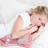 Girl snuggling with a warm and snuggly receiving blanket with a satin back, combining softness with a sleek, smooth finish.